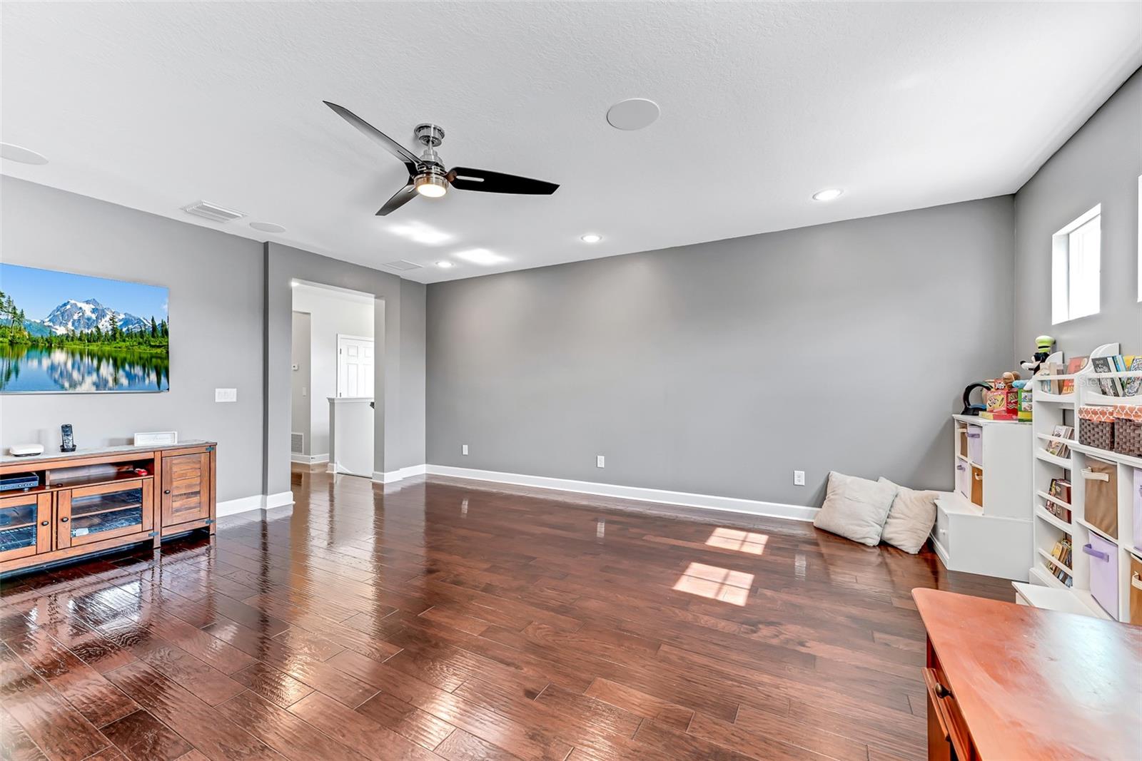 The 2nd-floor bonus room offers versatile space to suit your needs. The engineered hardwood flooring extends throughout the bonus room, primary bedroom, upstairs laundry, and the hallway leading to the secondary bedrooms.