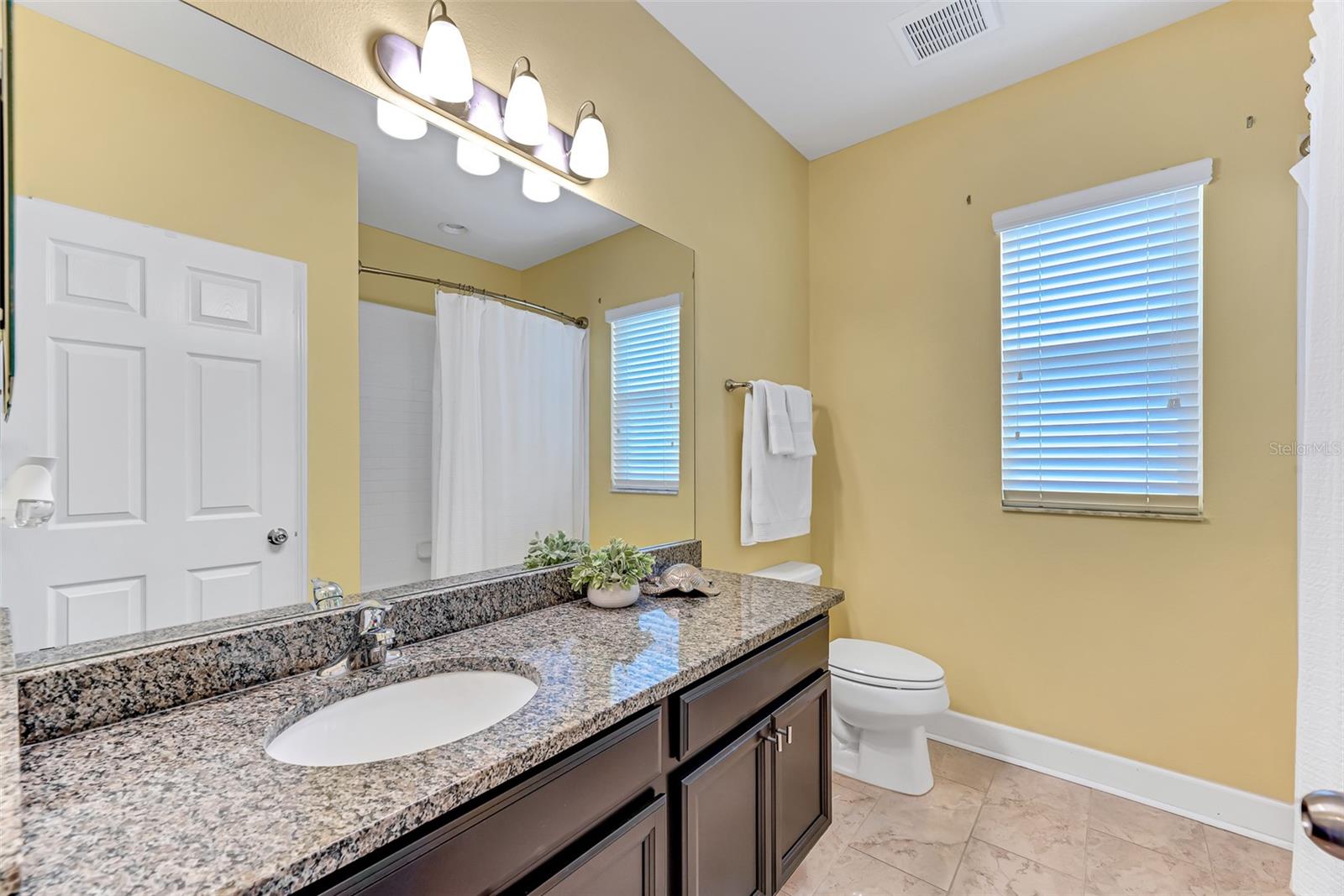 Full bathroom #2 on the second level features a spacious granite-topped vanity and a shower/tub combination.