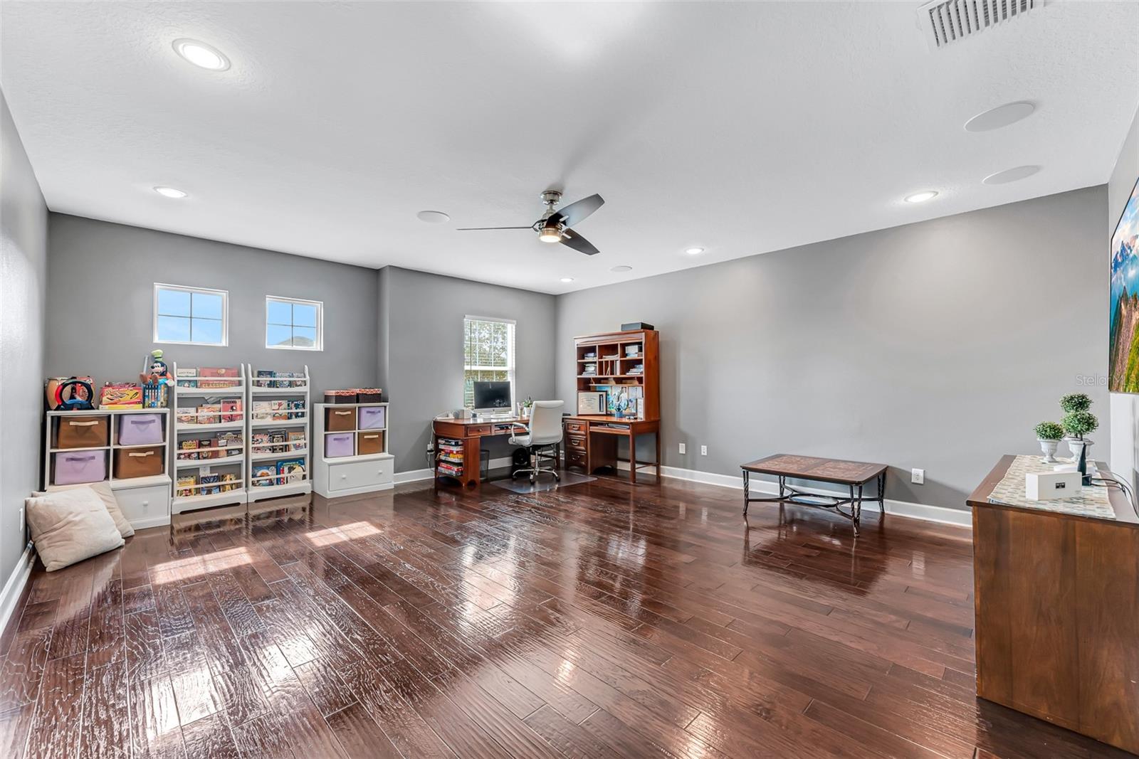 The 2nd-floor bonus room, featuring built-in surround sound, measures 19' x 21' and is perfect for a playroom, second living area, or home theater.