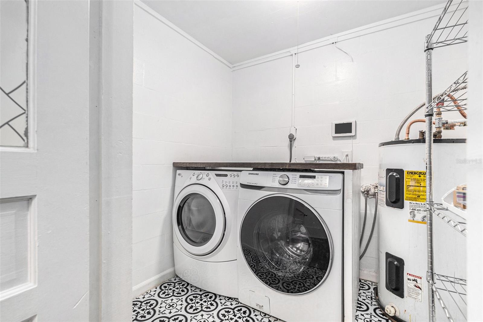 Laundry room with beautiful tile floors and a storage rack