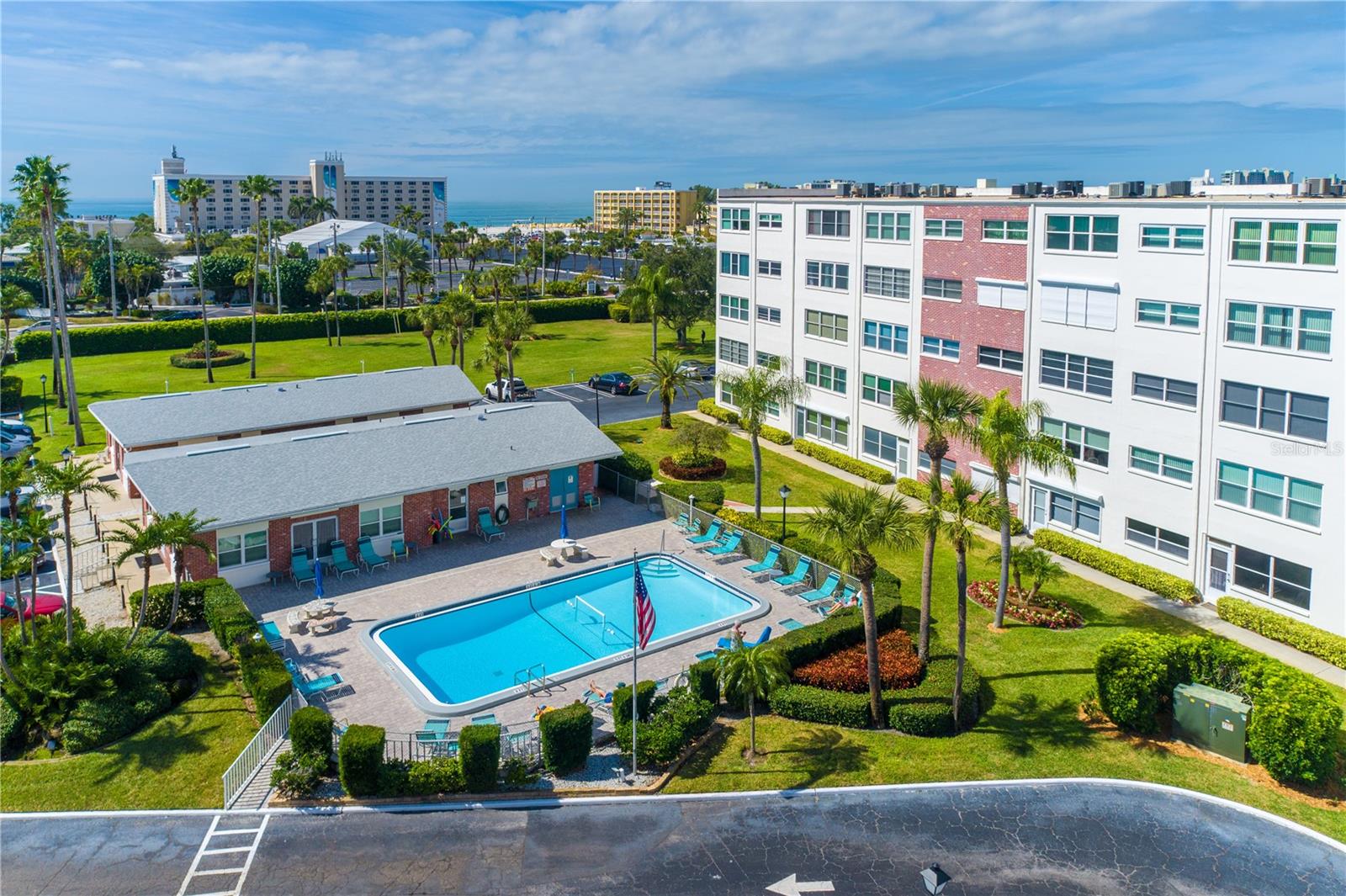 Western pool seen while sitting watching TV from the EXTRA Window. Picture shows Beach side Island View to Hotels and the 2 clubhouses, BBQ Area and Park facing the  Beach/RESORT and deeded Access.!