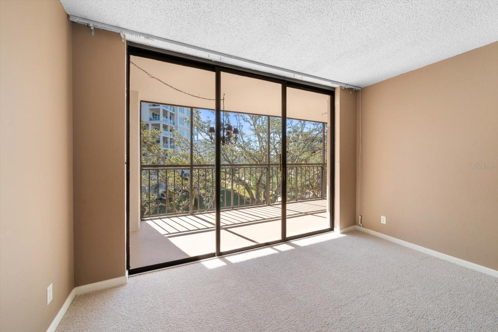 Sliding glass doors lead out to a spacious balcony