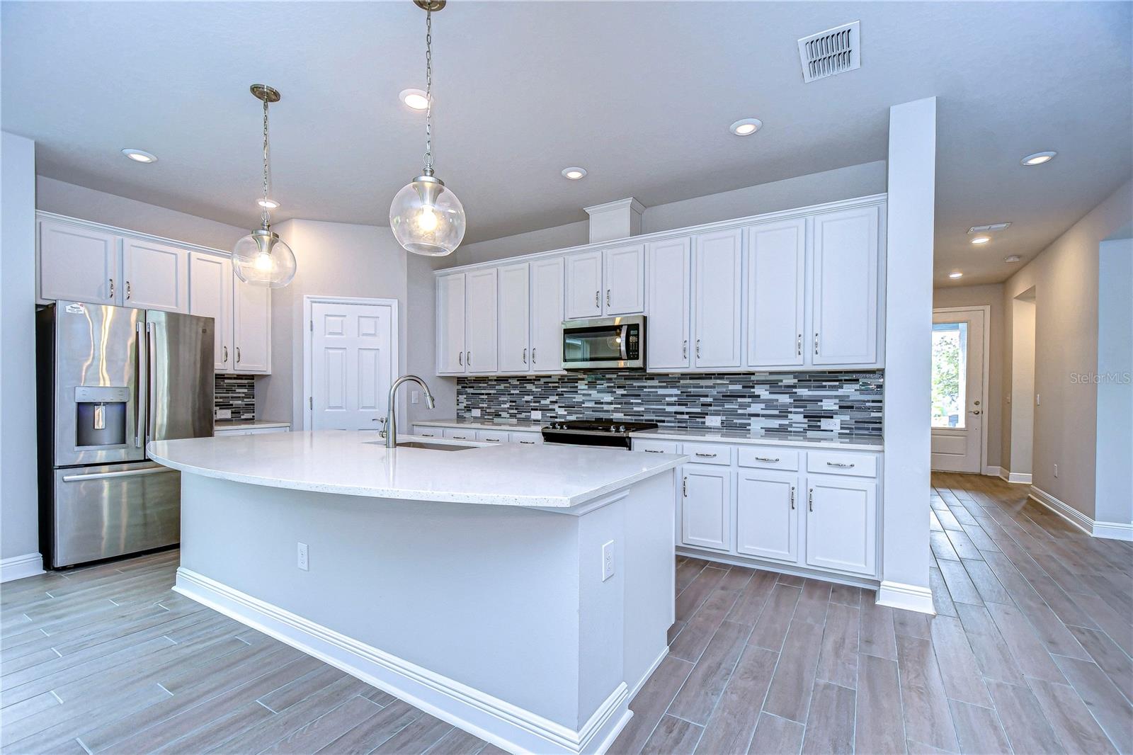Kitchen is well appointed with stainless steel appliances, gas stove and large island.