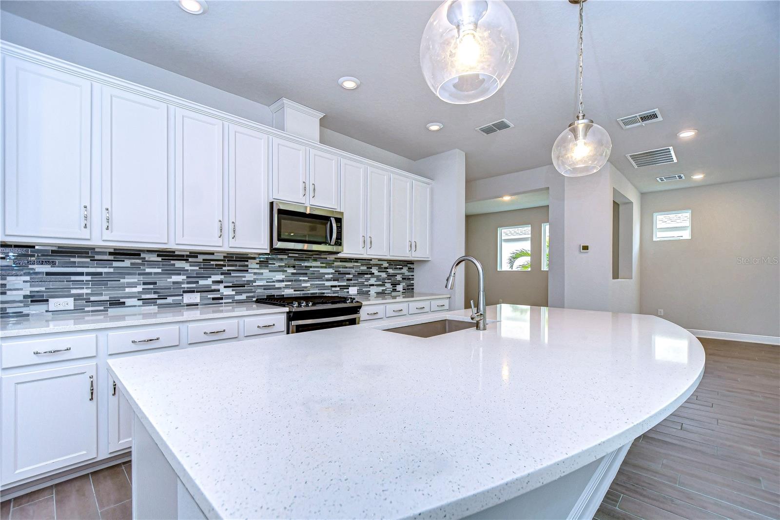 HUGE island features sink and large breakfast bar, great for quick and casual meals.