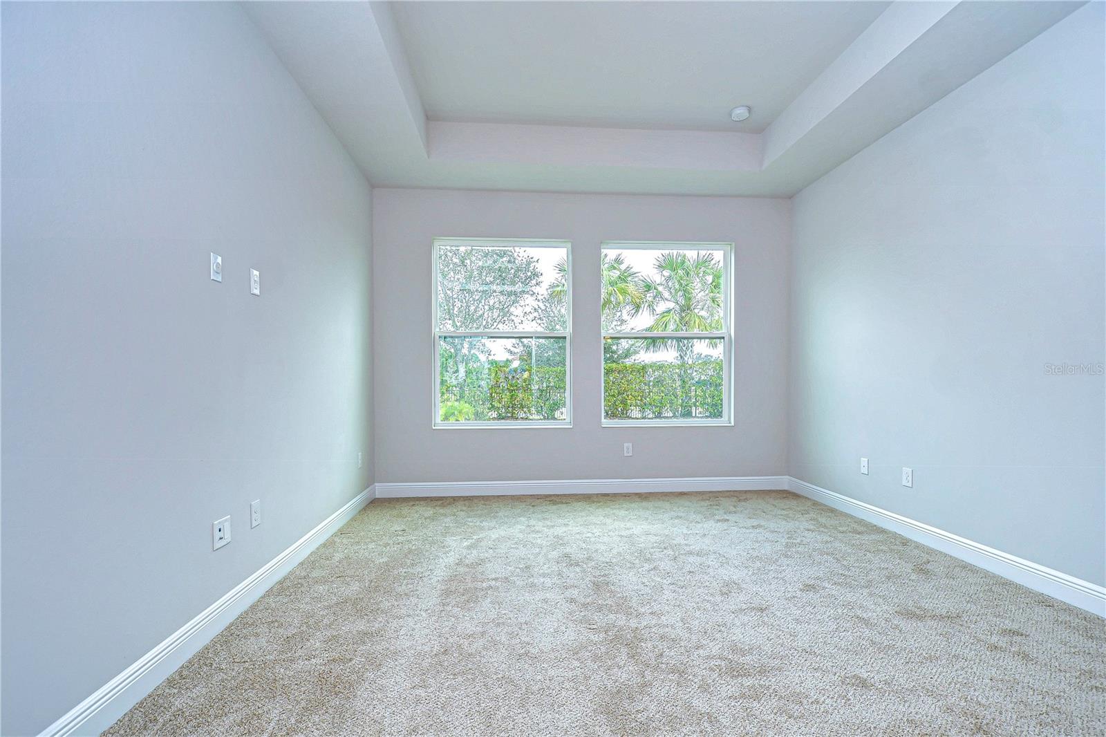 Primary suite features two large windows and trayed ceiling!
