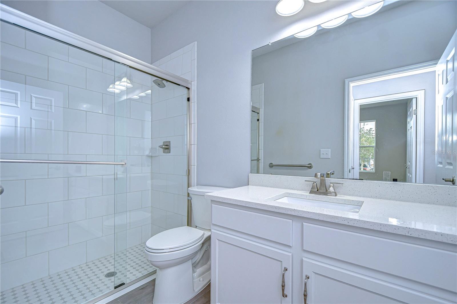 Bathroom features large shower and wonderful countertops.