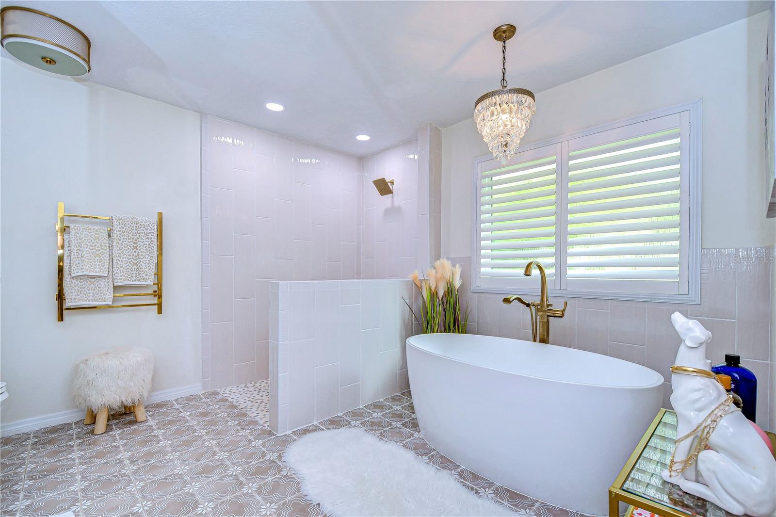 Unique walk in shower and stand alone soaking tub provide ultimate luxury.