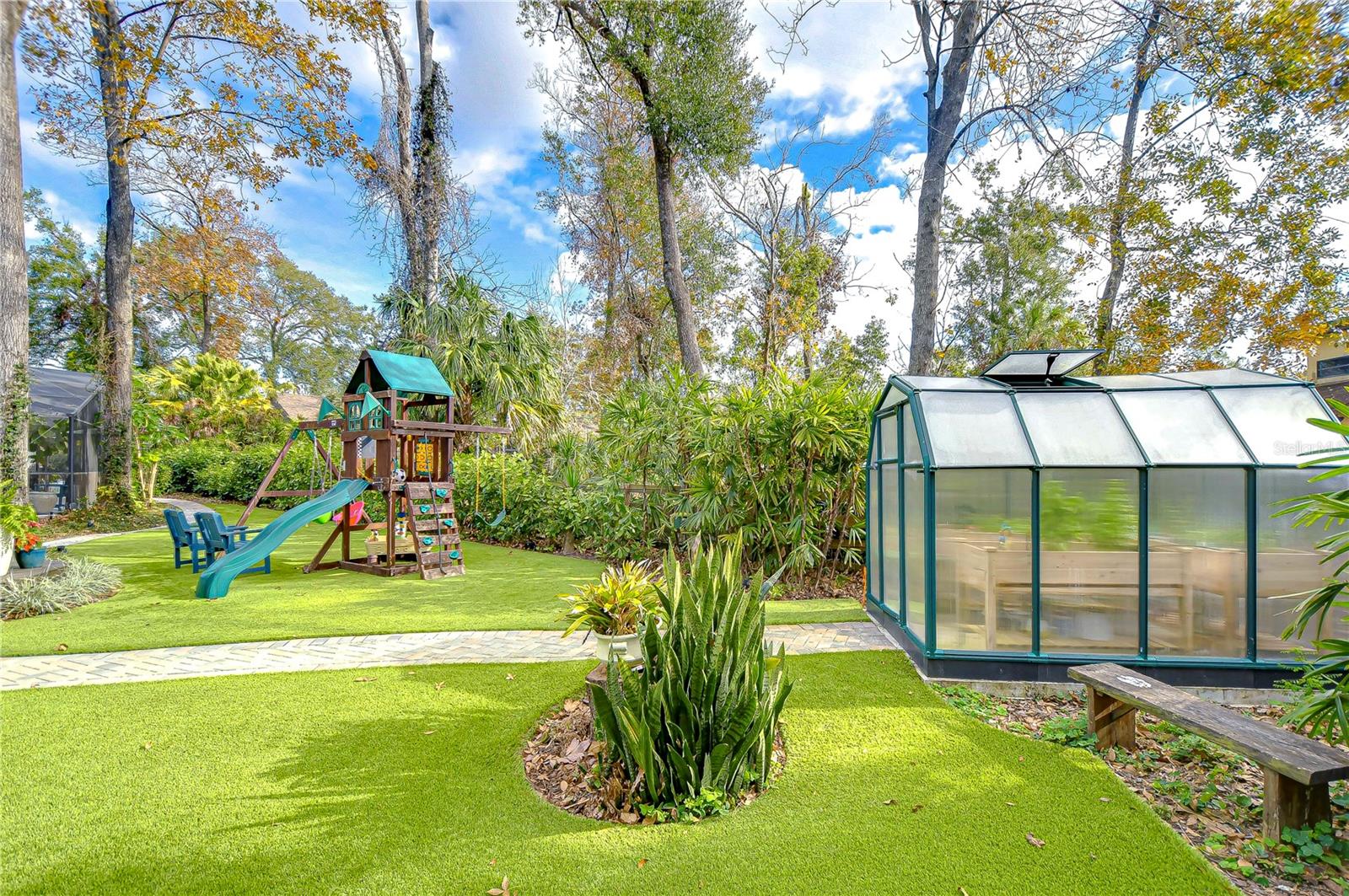 Green house located at the end of a pavered path!