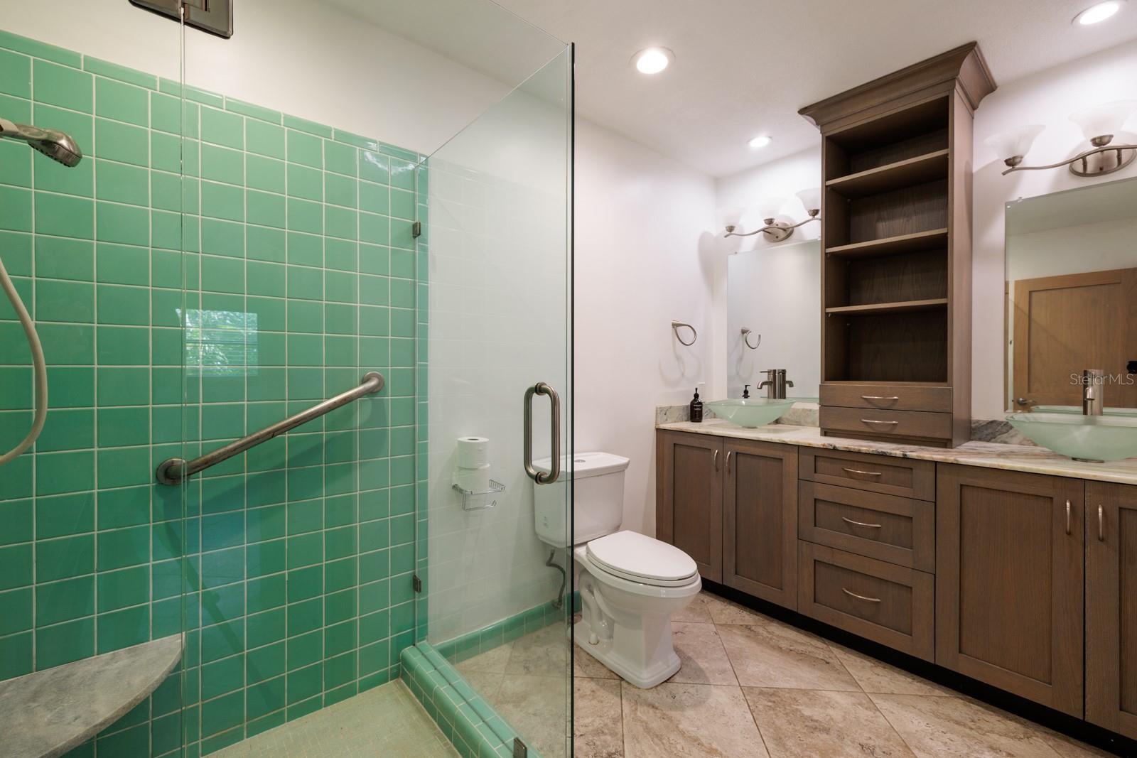 Primary bathroom with 2 vessel sinks & glass shower walls