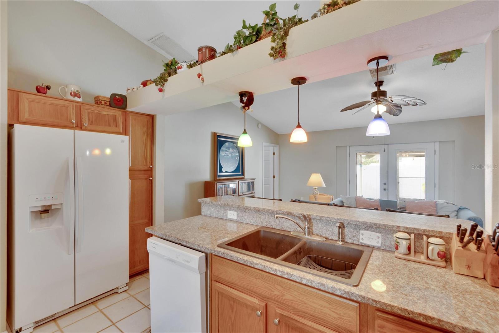 Kitchen with granite countertops and view into living room