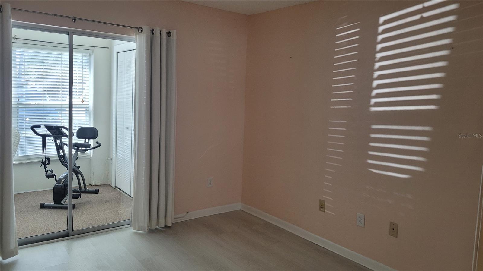 Guest bedroom with sliders to bonus room