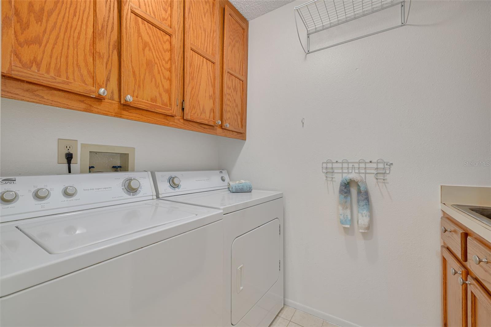 Inside laundry with cabinets and sink!