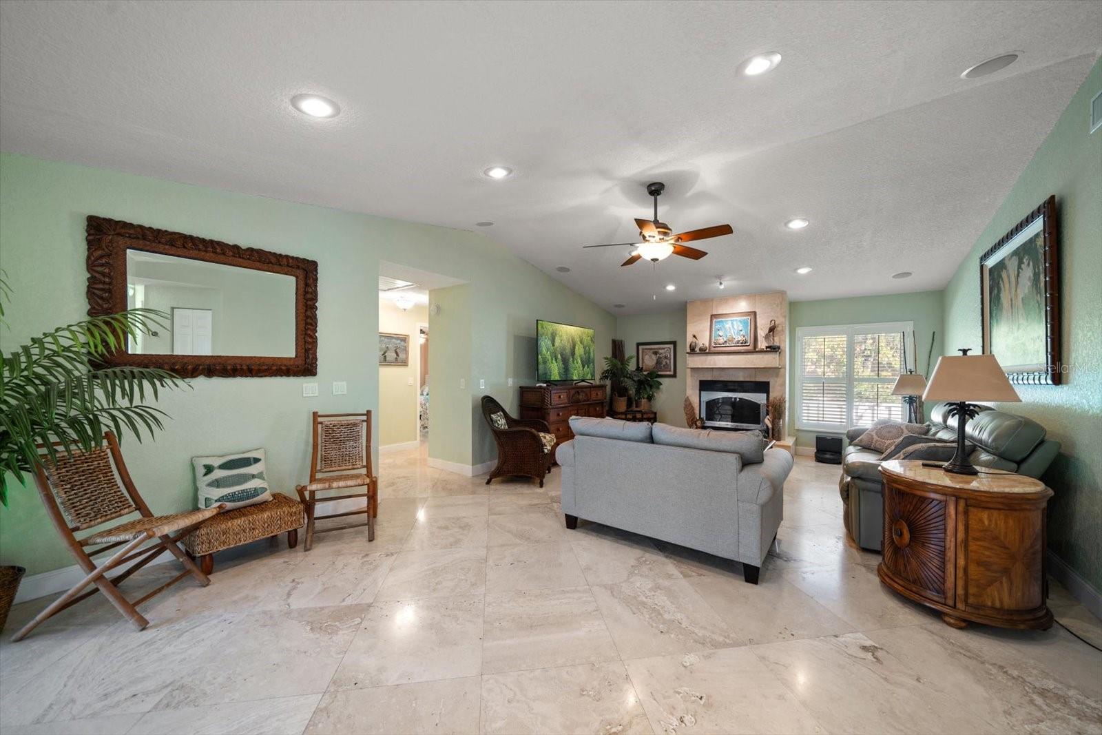 Feel the comforting embrace of this well-appointment family room, complete with vaulted ceilings, wood burning fireplace, and the perfect space to relax after a long day!