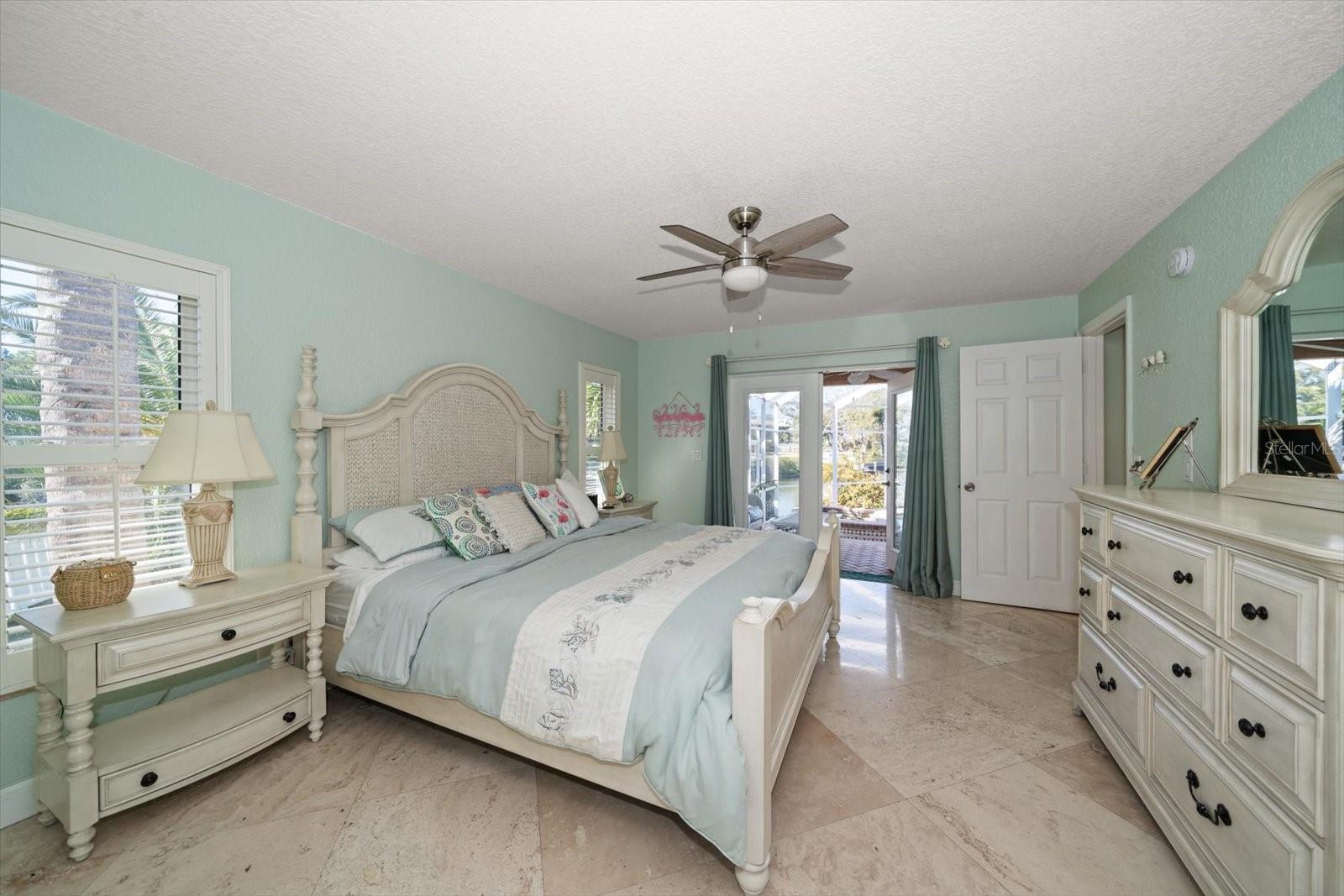 Natural light pours into the master suite from the beautiful French Doors leading out to the patio and pool area.