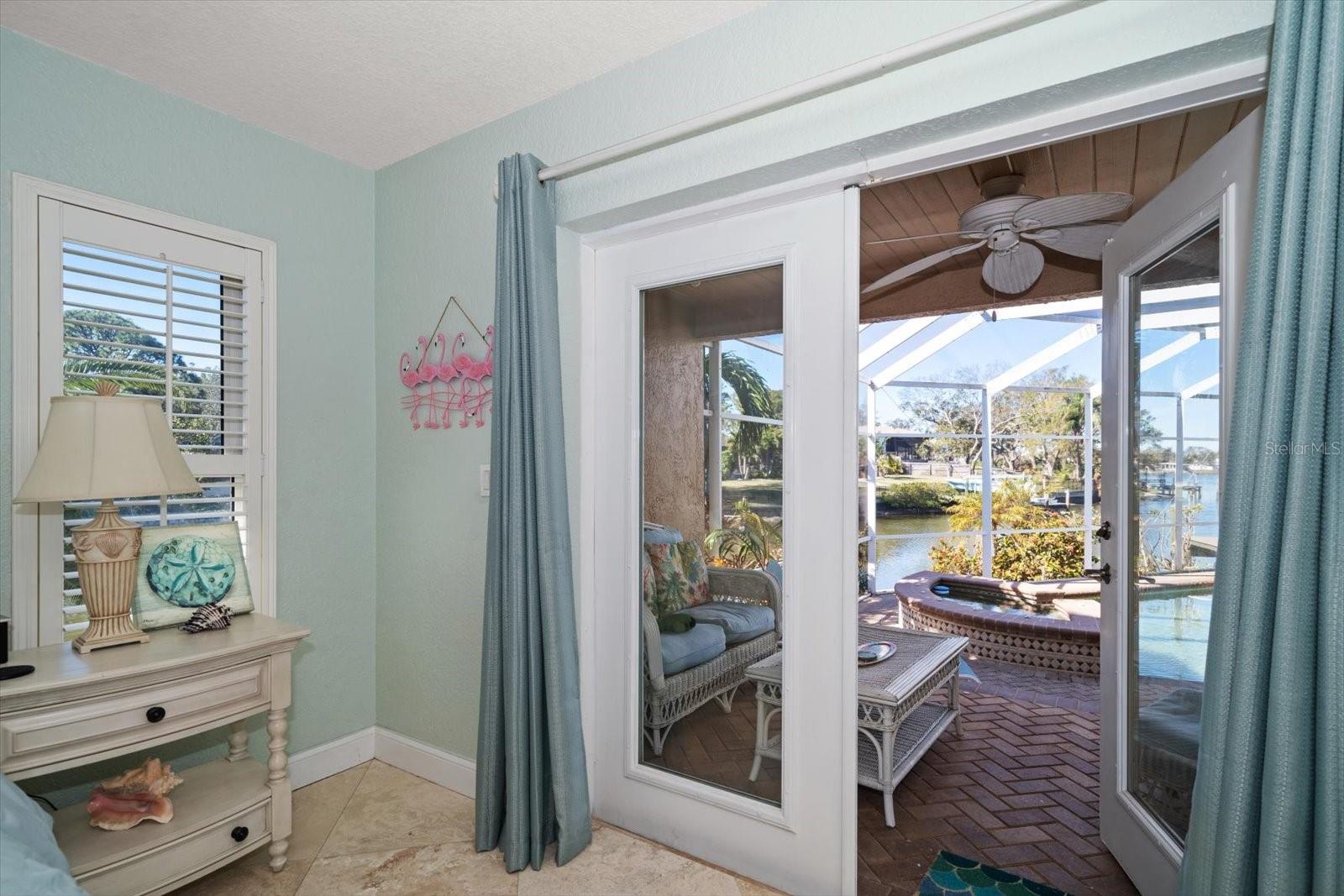 Natural light pours into the master suite from the beautiful French Doors leading out to the patio and pool area.