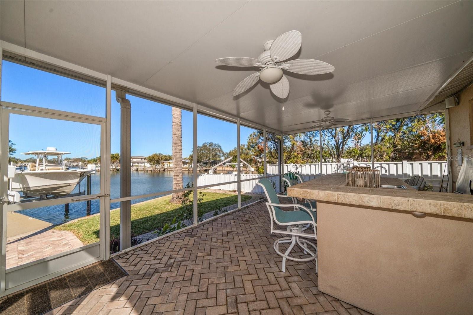 Outdoor kitchen under the covered patio area with plenty of space to roam and entertain.