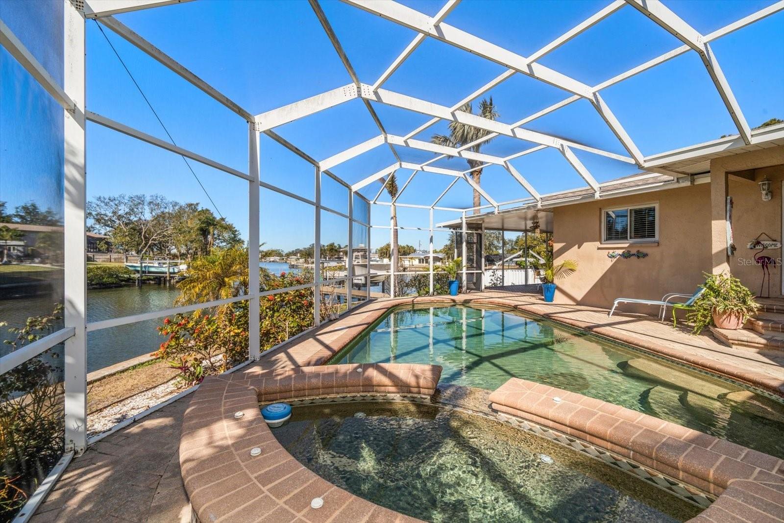 Brick pavers surround the pool area.