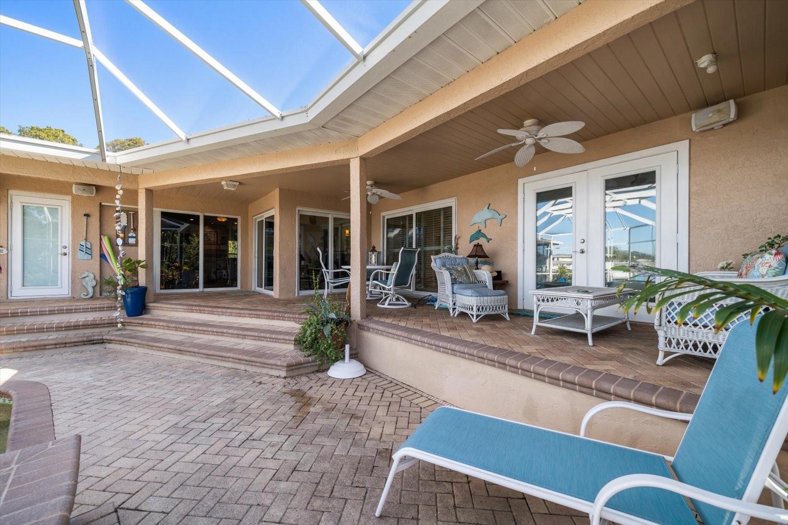 Several access points throughout the home lead to the magnificent outdoor living area, boasting over 700 square feet of covered patio area. Lounge, cook, enjoy outdoor meals or entertain in style, in this perfect oasis!