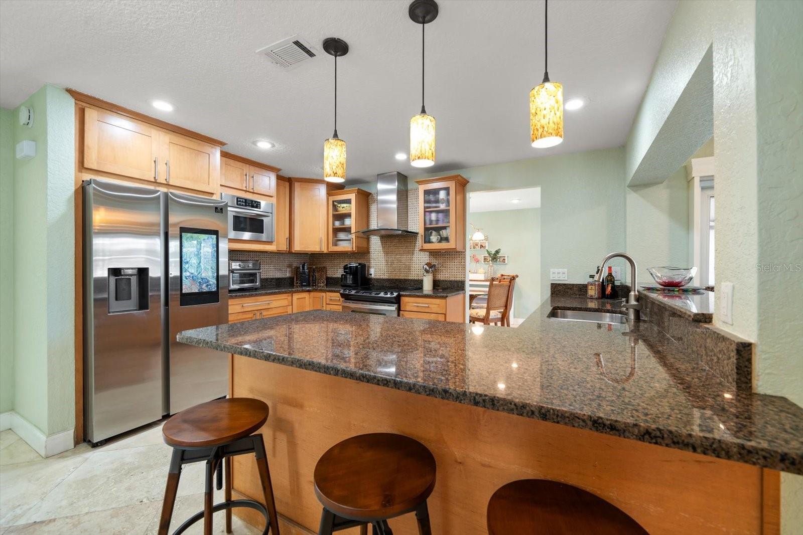 The heart of the home houses the charming kitchen, equipped with high-end appliances including a smart refrigerator, built-in microwave, hood vent and plenty of space to spread out and make a scrumptious meal.