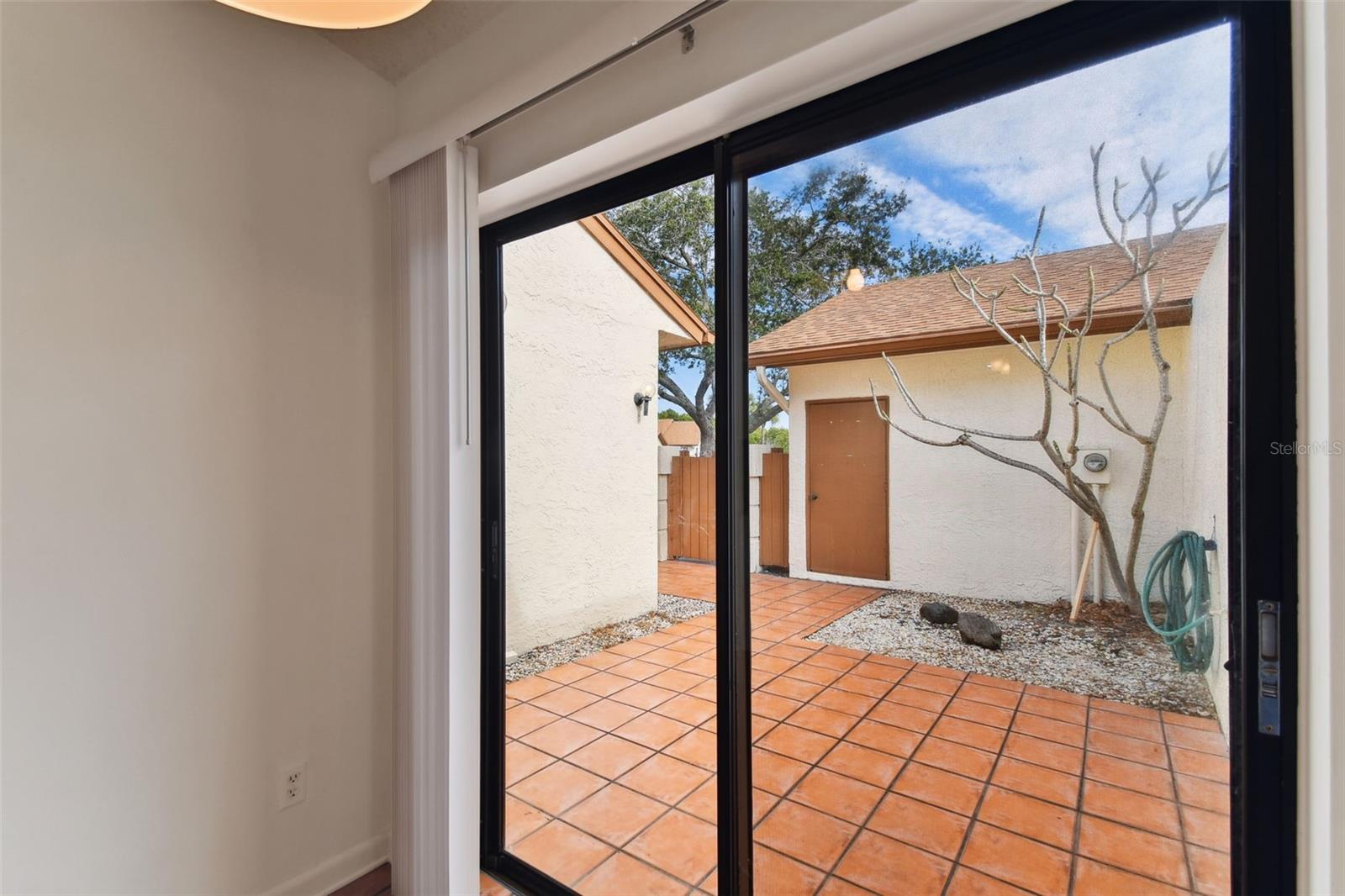 Sliding doors in kitchen area look out to the courtyard