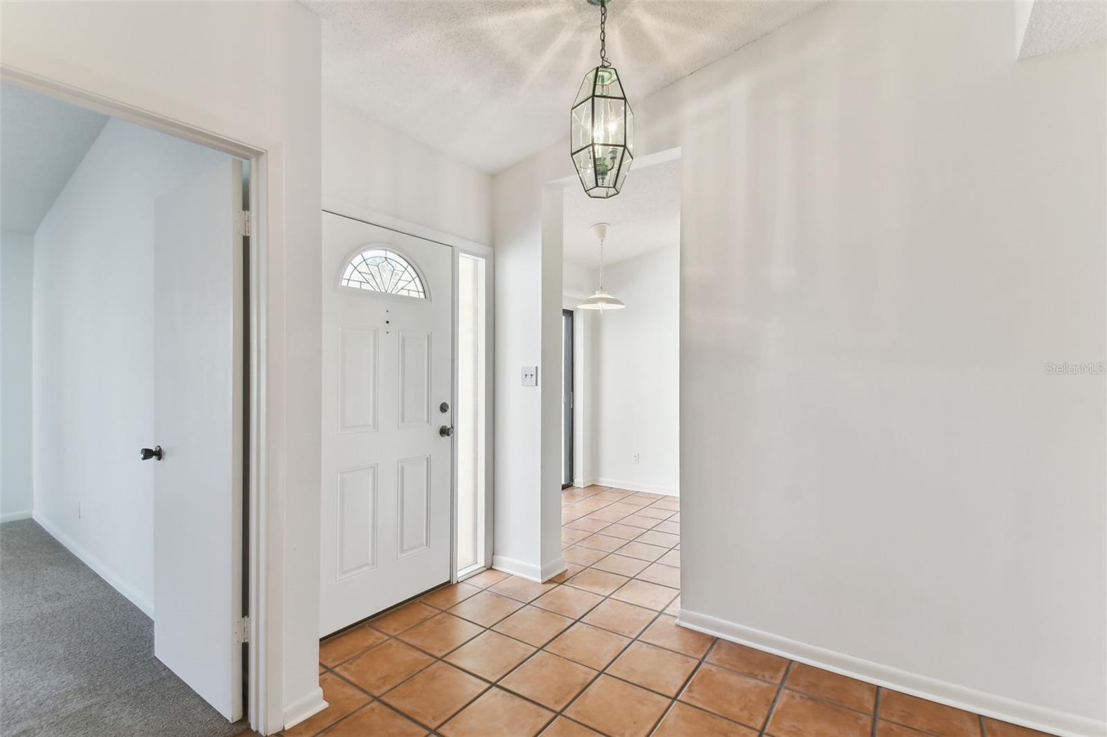 Front entry hall leading to main bedroom and kitchen