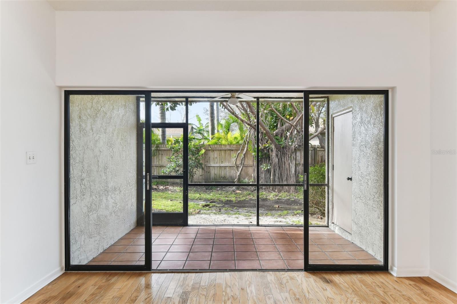 Sliding doors open to the screen enclosed rear porch