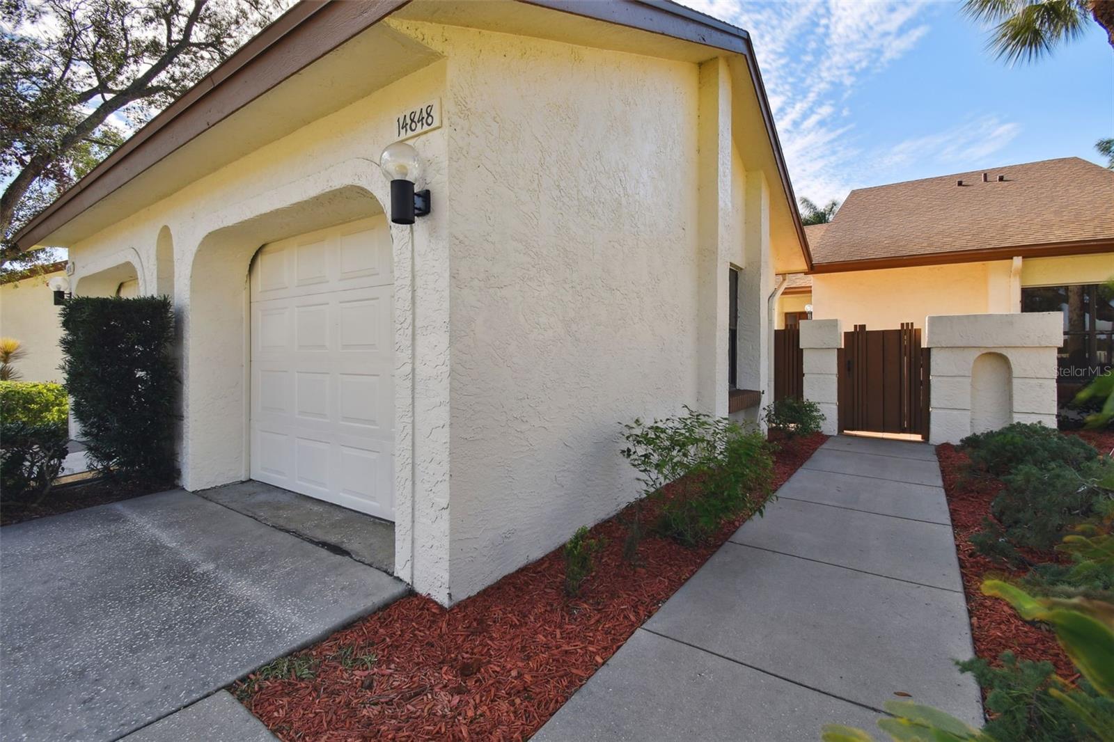 Front entry walkway with gated entry to courtyard