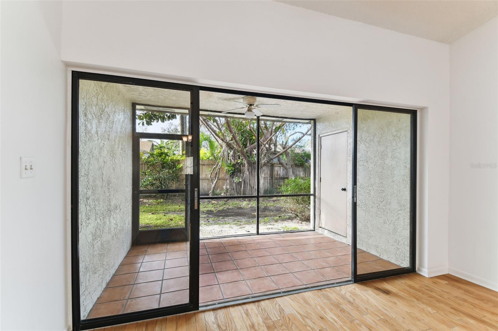 Sliding doors open to the covered screened porch