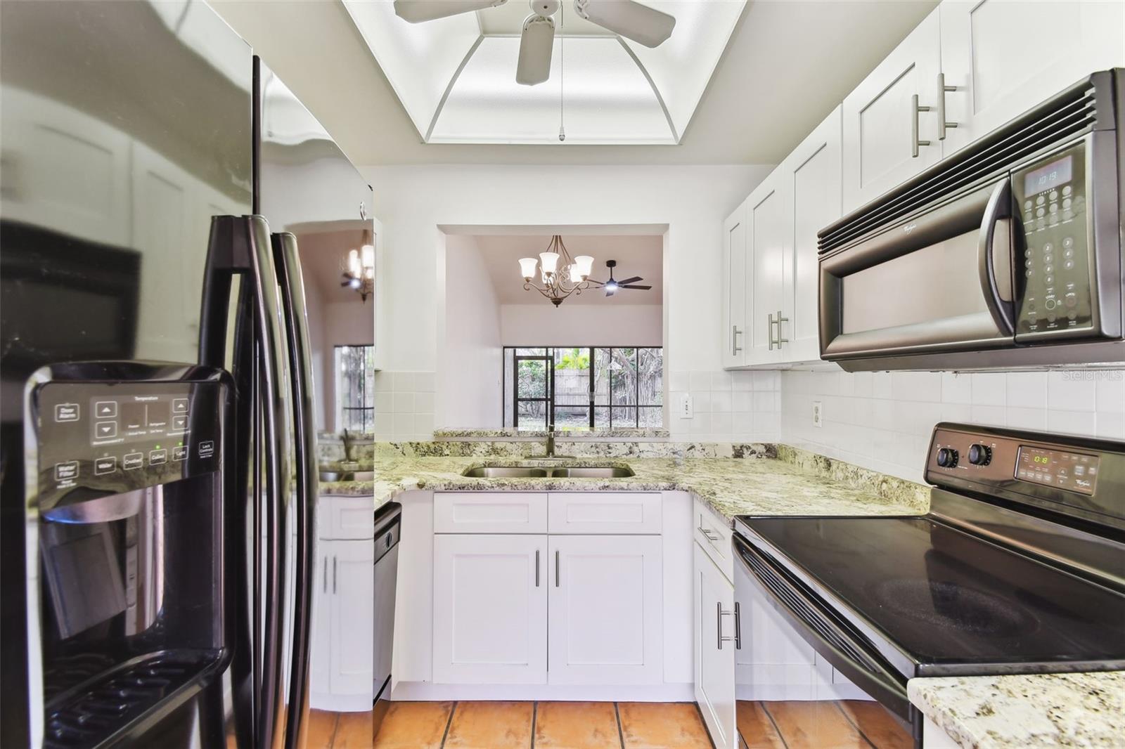 Updated kitchen with shaker cabinets and granite counters