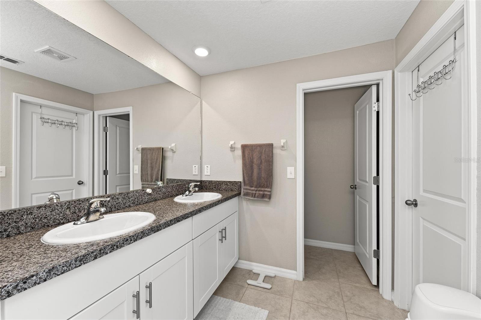 Primary bedroom ensuite bath with dual sinks.