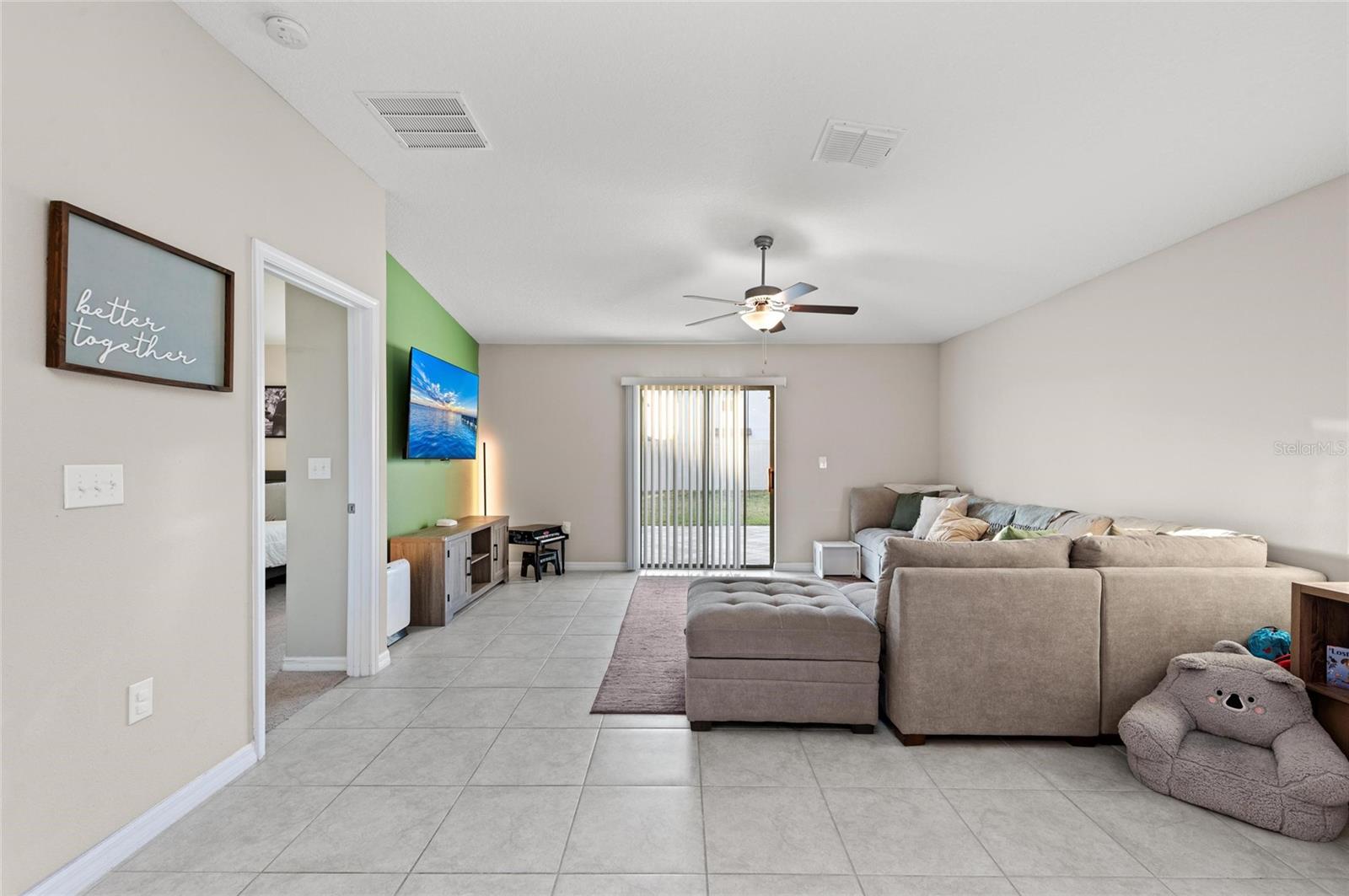 Large living room with sliding glass door to the back patio.