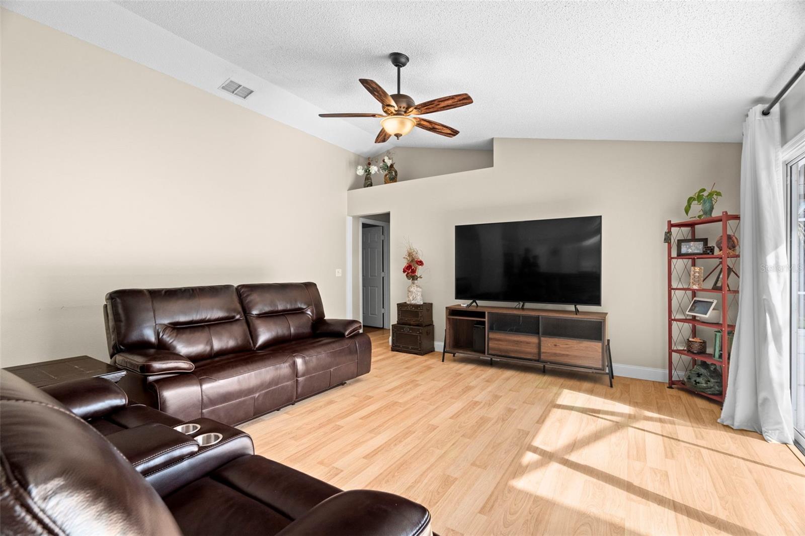 Family room with 2nd and 3rd bedrooms to the left, 4th bedroom to the back, and sliders to pool to the right.