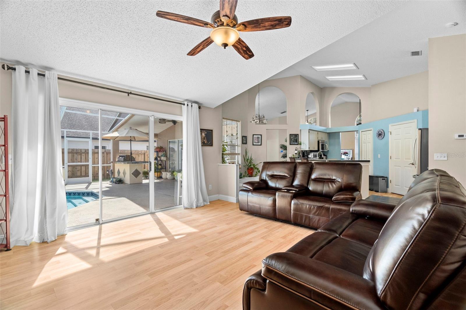 Family room with pool to the left, kitchen straight ahead, and 2nd and 3rd bedrooms to the right.