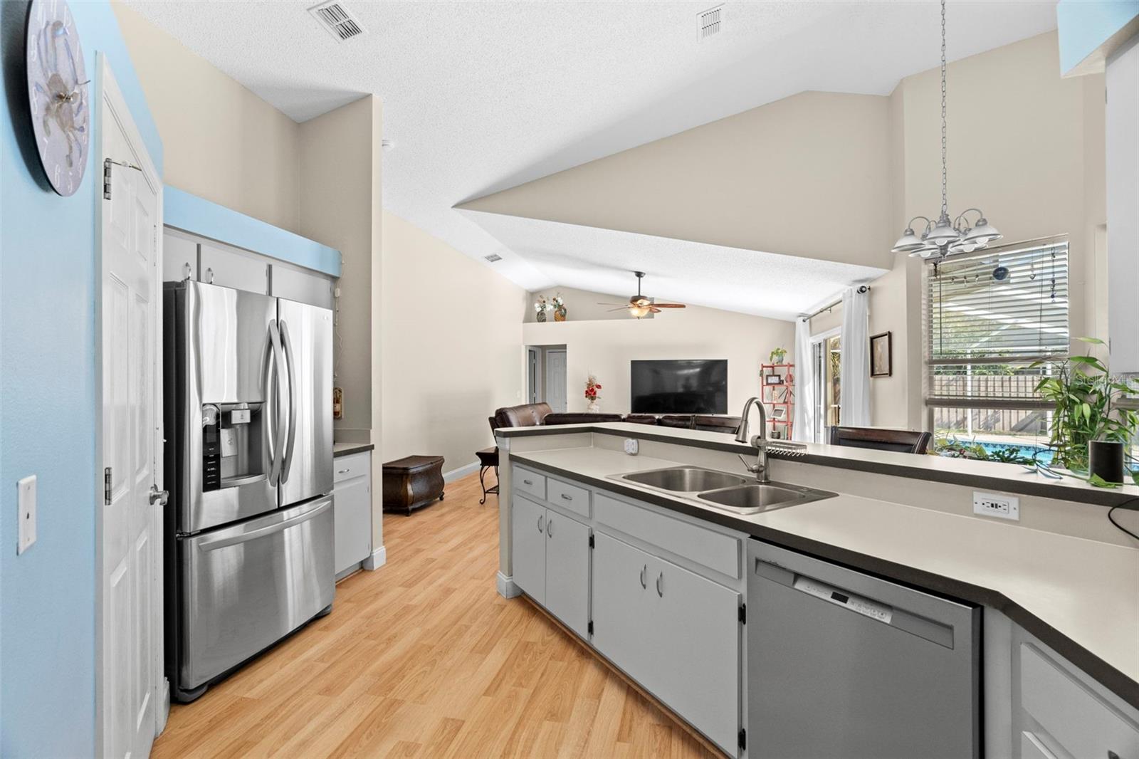 Door to left of refrigerator leads to laundry room and garage.