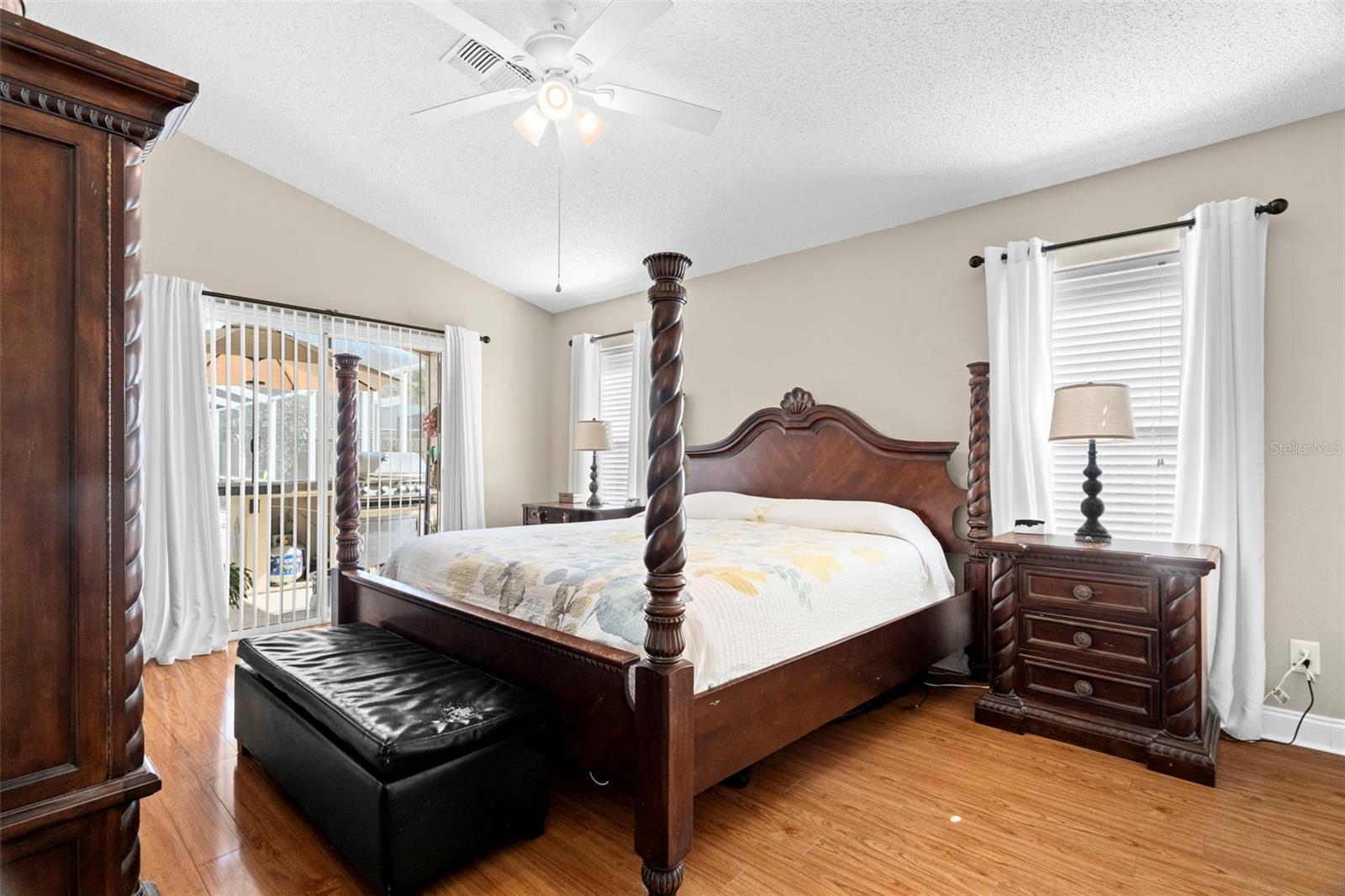 Primary bedroom with sliders to the pool