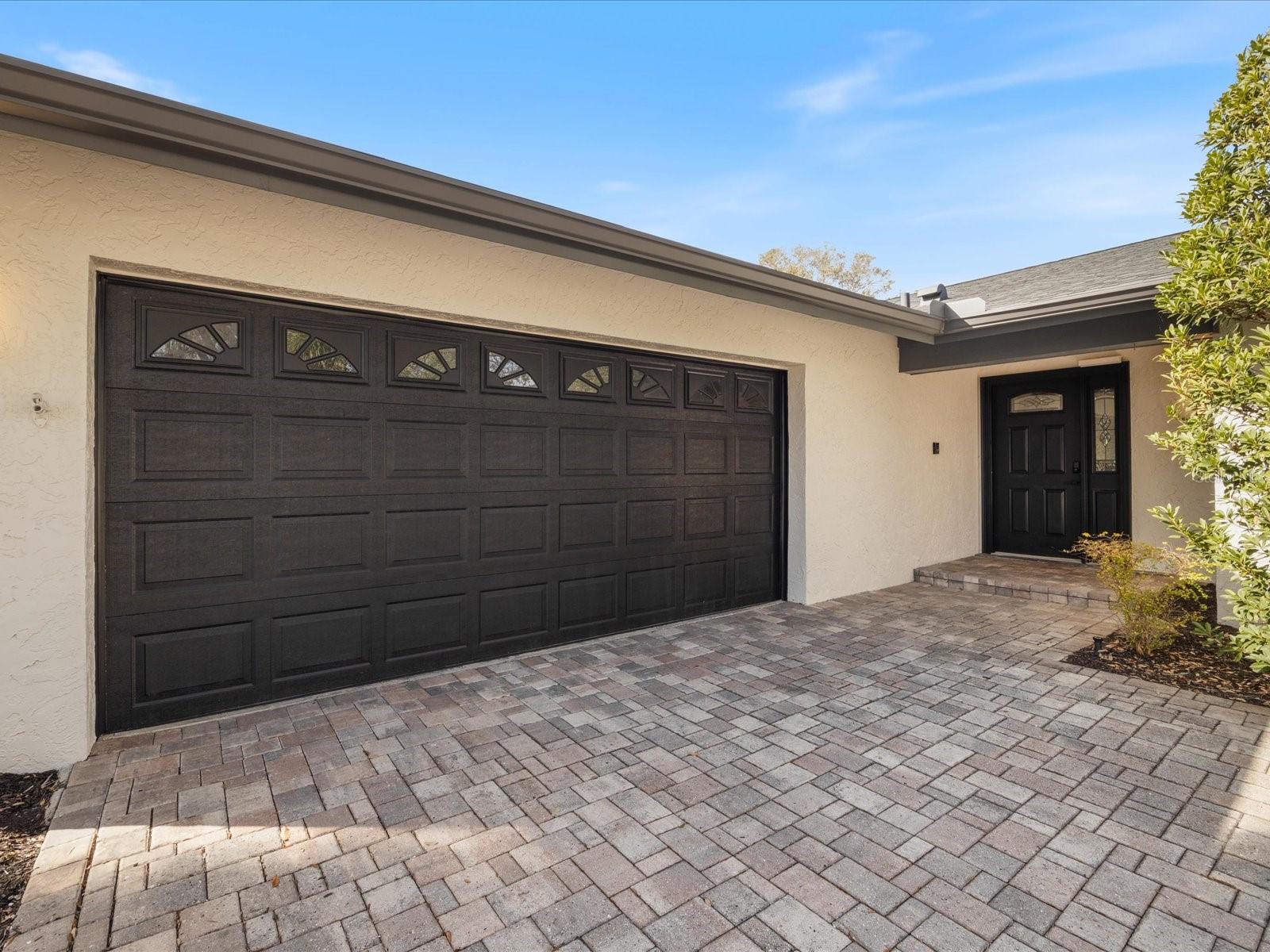 Beautiful pavers lead up to the 2=car garage and front entry door