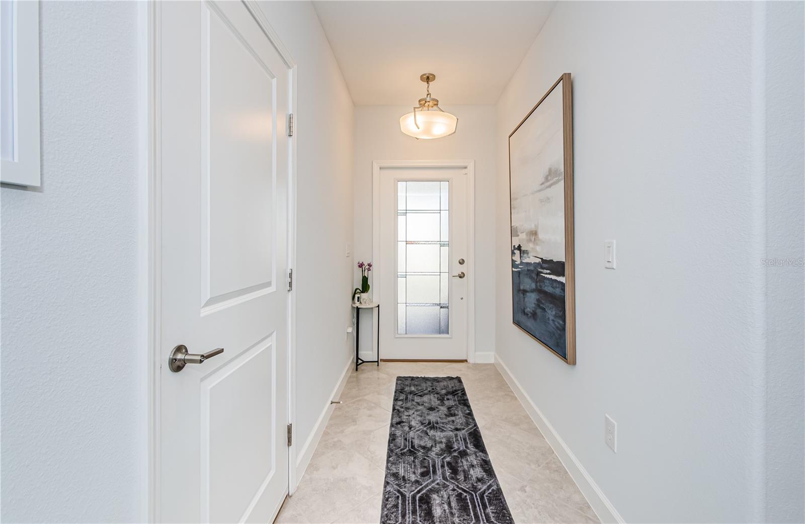 From the moment you walk in, you’ll feel the air of sophistication and comfort. This bright and open foyer features sleek tile flooring and a neutral color palette create a modern, airy feel, leading seamlessly into the heart of the home.