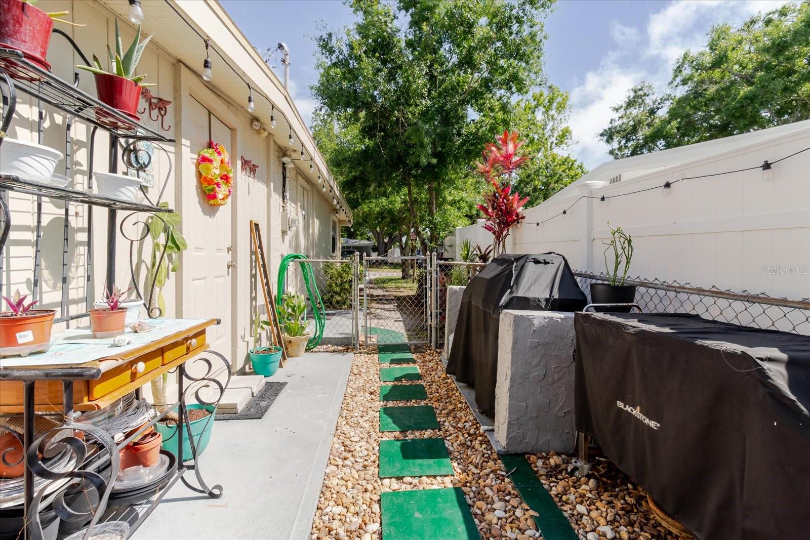 West Side of the House With Gardening and Grilling Area. Door With The Wreath Leads To The Kitchen
