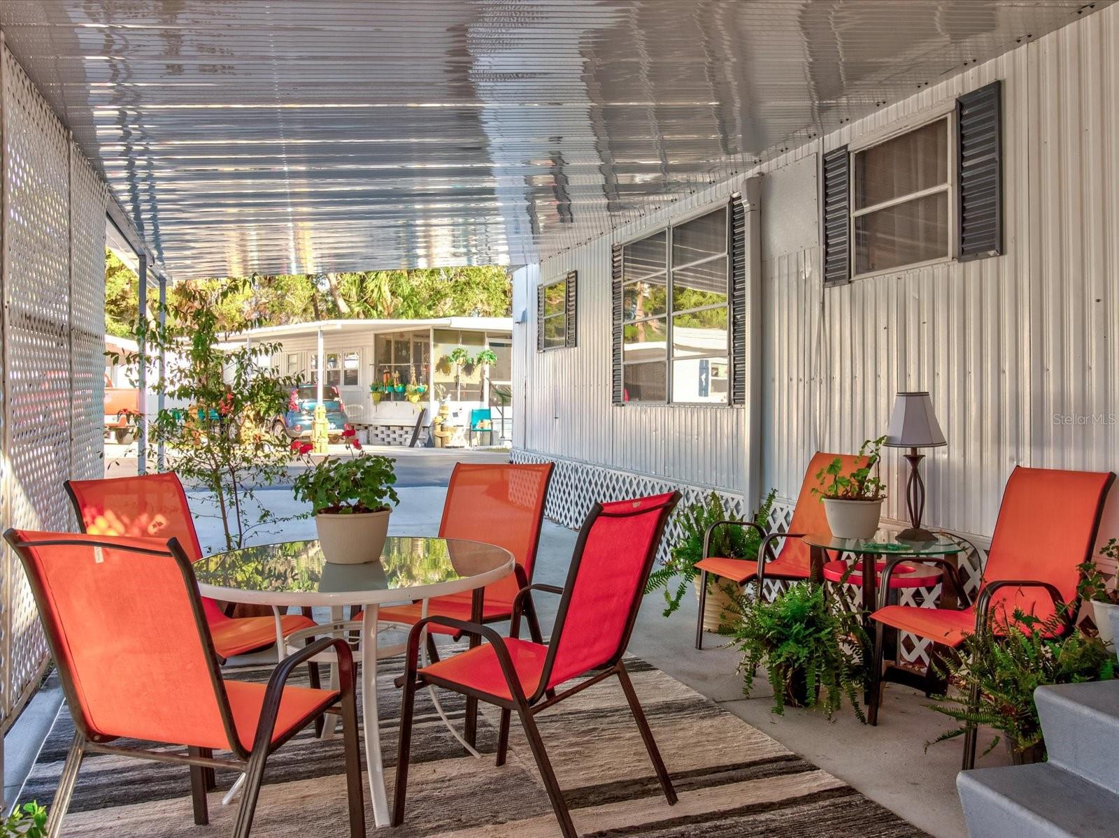 Two Car Carport With Patio Seating, Laundry Shed and Extra Parking Pad For Third Vehicle