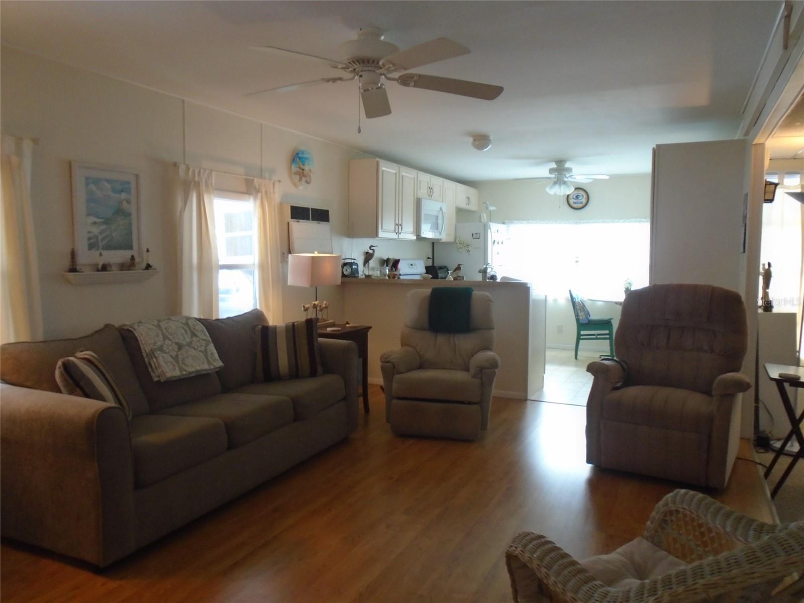 Living Room to Kitchen * Note Queen Size Sleeper Sofa * Most Furniture is Included * Note Drywall on Ceiling and Walls in the Kitchen & Living Room Ceiling * Xtra Nice Vinyl Laminate Flooring