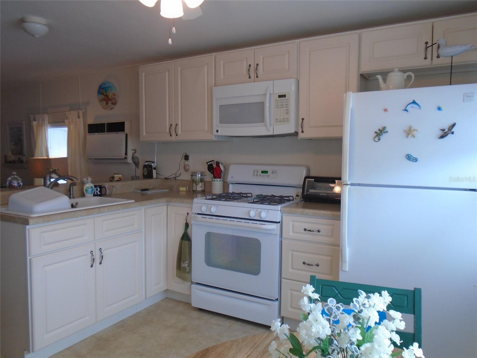 Updated Kitchen is Open to the Living Room & Family Room * Microwave * Gas Stove * Gas is Included in the Monthly Maintenance