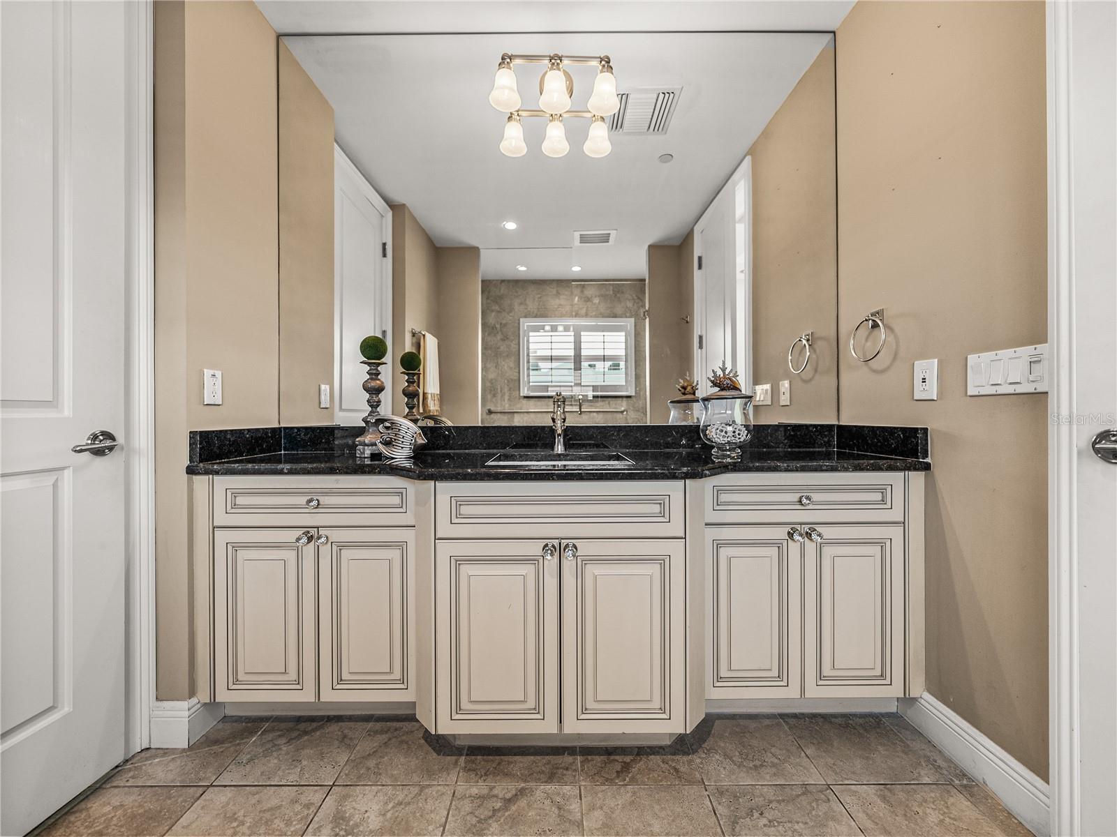 As is the case for all cabinetry, it is all-wood and has granite countertops.