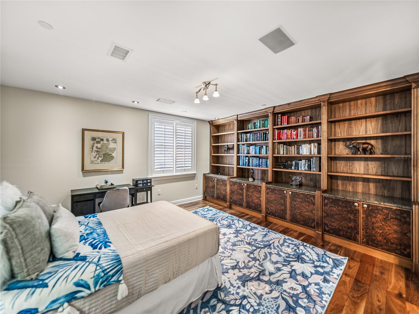 This is the third bedroom. It previously served as an office. The custom walnut shelving and cabinets also lend this room to being a library. And with plenty of room for a stylish sofa bed... the room can serve multiple purposes at once! It is ensuite.