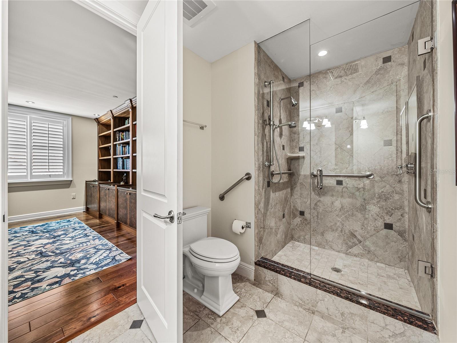 The walk-in shower has both a handheld shower and grab bars for safety. The frameless shower enclosure is an elegant addition.  And of course, it is a comfort-height toilet.