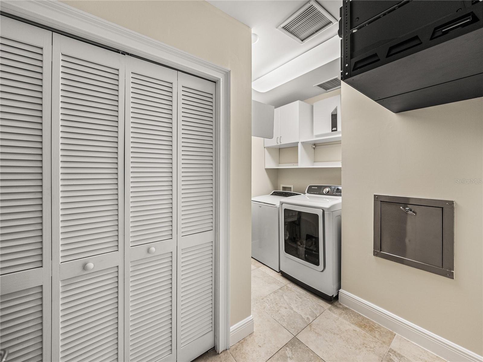 The laundry room has a gas dryer.  Behind the louvers doors is the HVAC unit for the east end of the unit and the hot water heater.