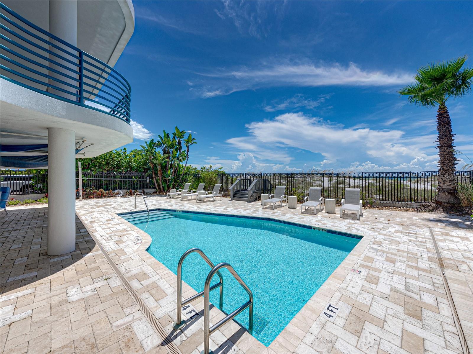 The travertine pavers are lovely and provide plenty of space for enjoying the poolside.