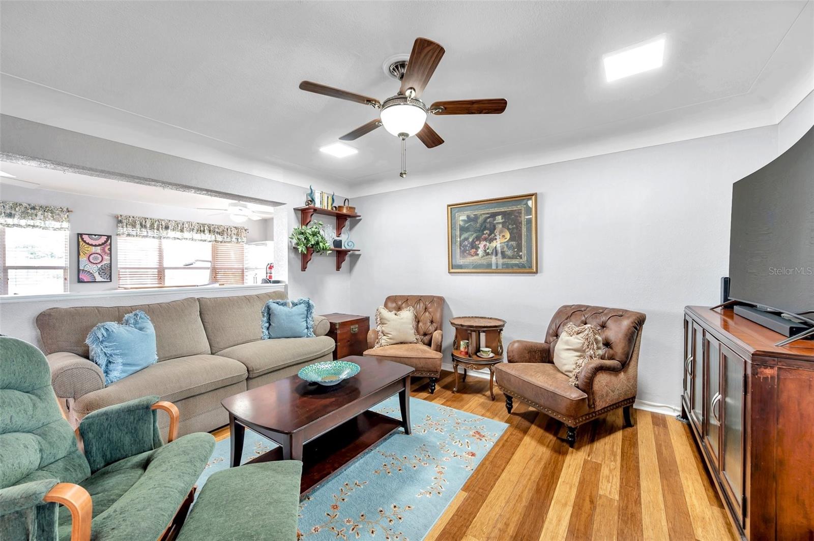 Living room and notice the coved ceilings and beautiful bamboo flooring.