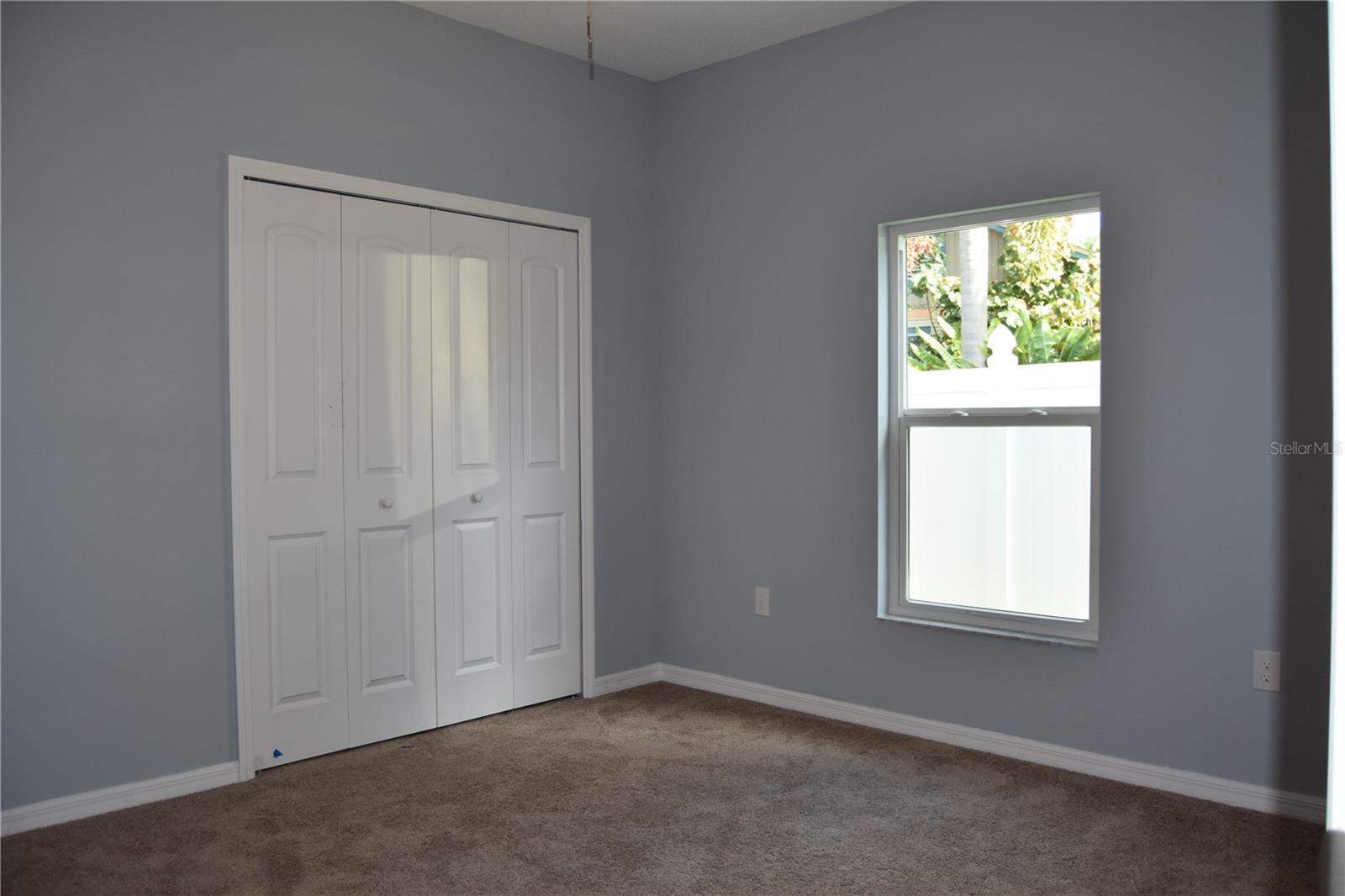 High ceilings make even the guest bedrooms seem spacious.