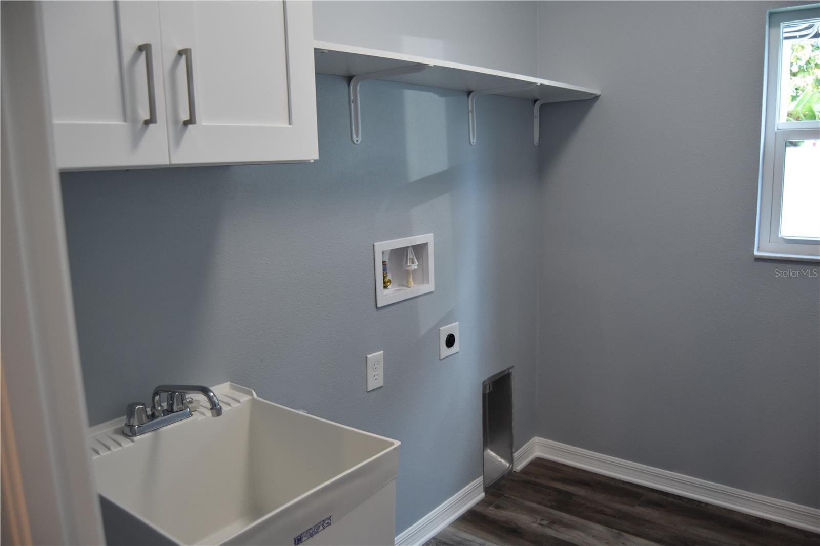 spacious laundry room with sink.