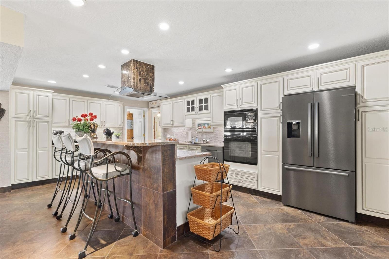 A Country French island kitchen is one of the highlights.